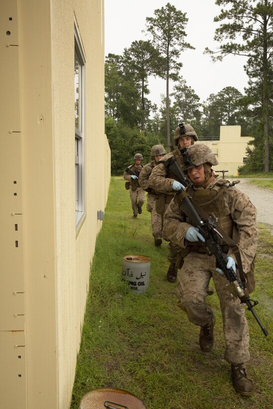 U.S. Marine Corps Lance Cpl. Kevin VegaNunez, Alpha Co., Battalion Landing Team 1st Battalion, 6th Marine Regiment, 22nd Marine Expeditionary Unit (MEU), team leader and native of Louisville, Ky., rushes with his site exploitation team to enter a building during a vertical assault course at Marine Corps Base Camp Lejeune, N.C., Aug. 17, 2013. The MEU is scheduled to deploy in early 2014 to the U.S. 5th and 6th Fleet areas of responsibility with the Bataan Amphibious Ready group as a sea-based, expeditionary crisis response force capable of conducting amphibious mission across the full range of military operations. (U.S. Marine Corps photo by Sgt. Alisa J. Helin/Released)