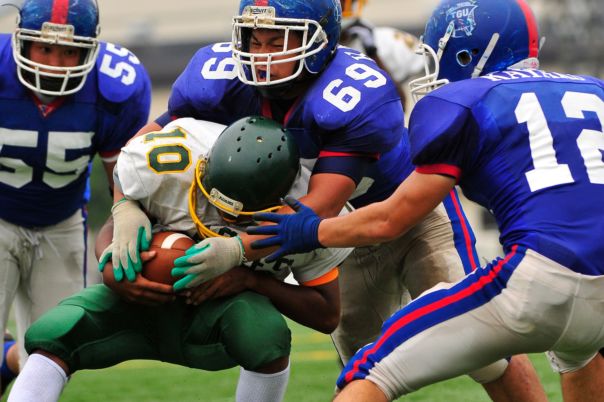 Edgren High School Quarterback Khaleem Shabazz pushes for extra yards during the first day of the bilateral training camp with the Tohoku Gakuin University at Misawa Air Base, Japan, Aug. 16, 2013. The TGU football team is the number two team in Division I colleges for Japan. Coach Miller believes that the opportunity to face the bigger TGU opponents will help the Eagles going into the season. (U.S. Air Force photo by Staff Sgt. Nathan Lipscomb)