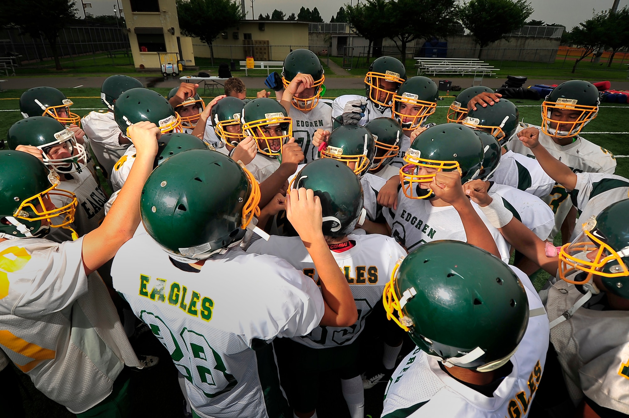 The Edgren High School football team huddles up before the first practice of the bilateral training camp with the Tohoku Gakuin University at Misawa Air Base, Japan, Aug. 16, 2013. The Edgren Eagles hope to win the Far East Division II title after losing to the Camp Zama Trojans last year. (U.S. Air Force photo by Staff Sgt. Nathan Lipscomb)