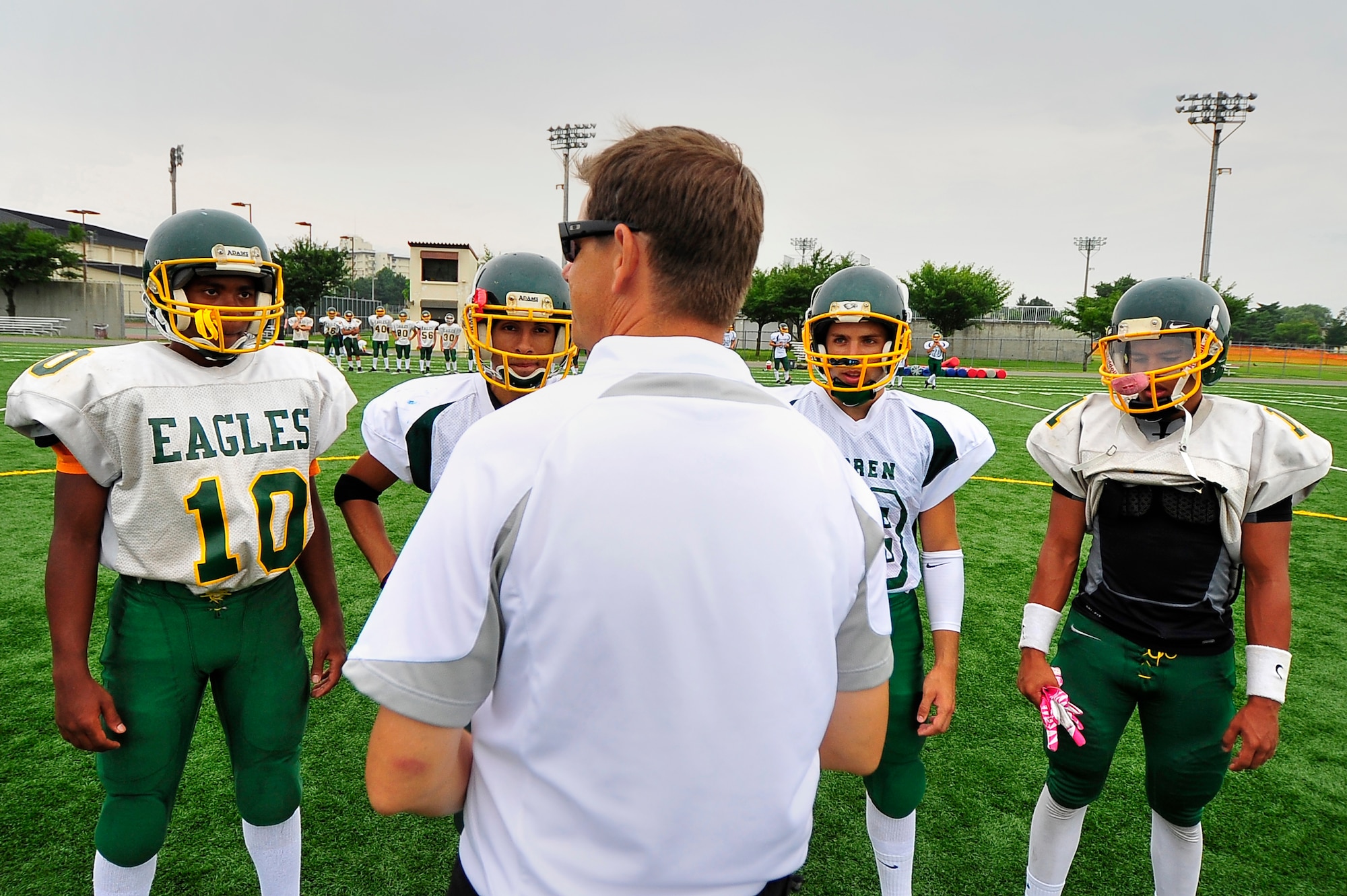 Blaine Miller, Edgren High School football coach, goes over the game plan with his team captains before the first day of the bilateral football camp with the Tohoku Gakuin University at Misawa Air Base, Japan, Aug. 16, 2013. Coach Miller believes that the opportunity to face the bigger TGU opponents will help the Eagles going into the season. (U.S. Air Force photo by Staff Sgt. Nathan Lipscomb)