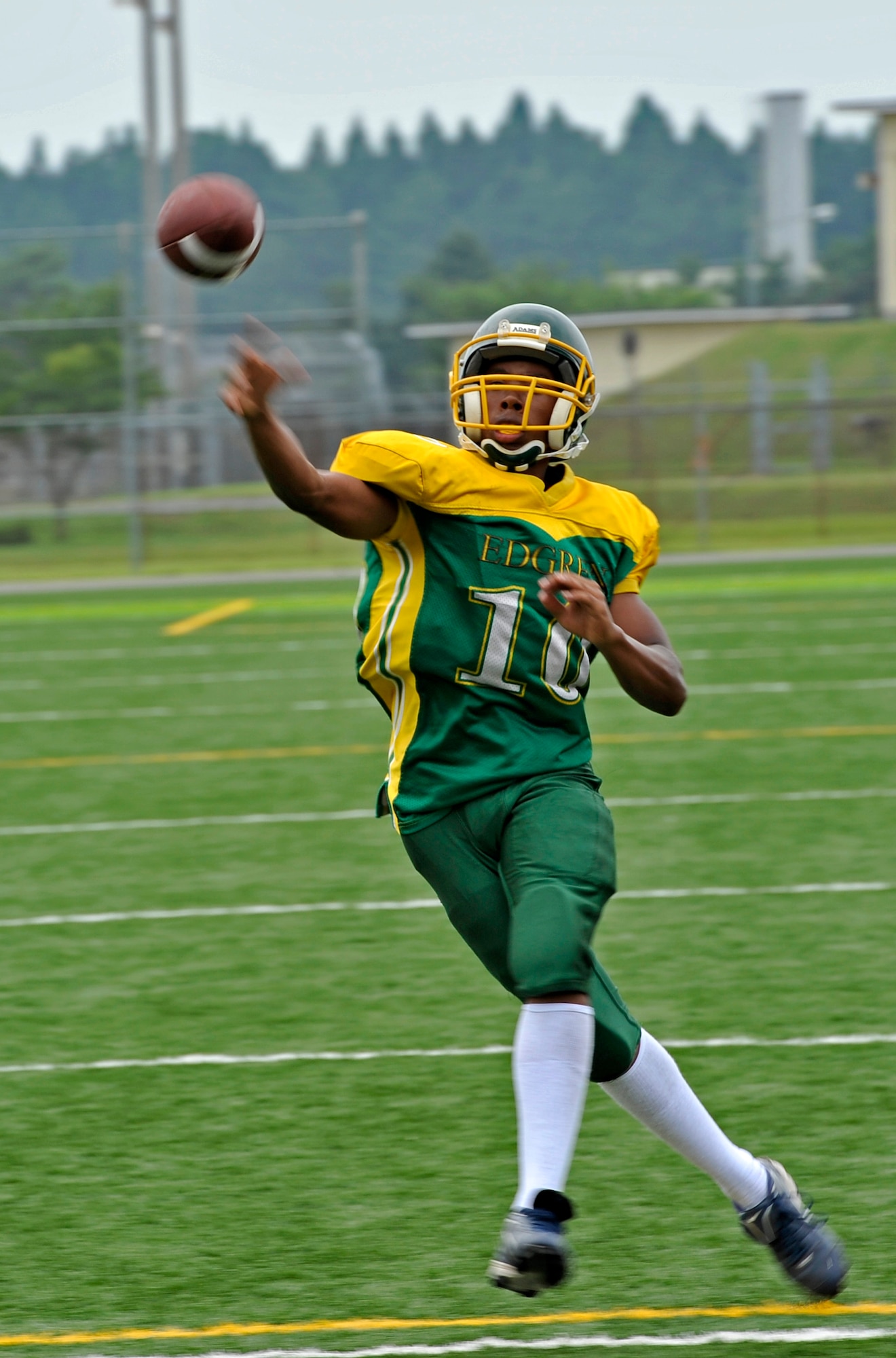 Khaleem Shabazz, Edgren High School sophomore quarterback, attempts a pass as he scrambles to his right during a scrimmage against the Tohoku Gakuin University football team at Misawa Air Base, Japan, Aug.18, 2013. Shabazz led the Eagles to a 14-14 tie while throwing for two touchdown passes, with one coming in the closing seconds of the game. (U.S. Air Force photo by Airman 1st Class Zachary Kee)