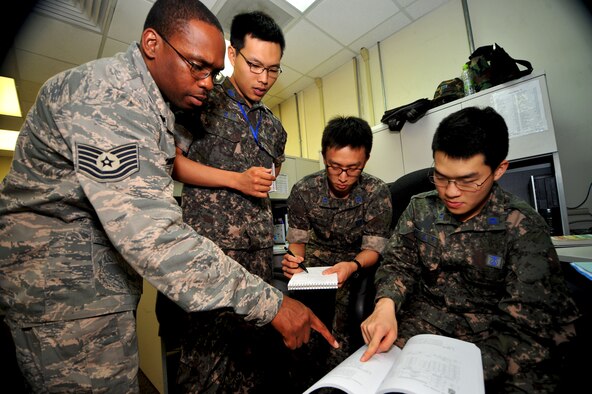 Republic of Korea and U.S. Air Force Airmen from the Air Component Command plans and coordination team coordinate efforts between ROK and U.S. forces during an exercise scenario as part of Ulchi Freedom Guardian at Osan Air Base, ROK, Aug. 22, 2013. The annual exercise, conducted by the ROK and U.S. Combined Forces Command, runs through Aug. 30. (U.S. Air Force photo/Staff Sgt. Emerson Nuñez)