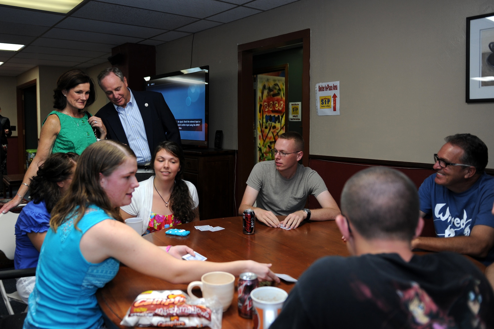 Air Force Chief of Staff Gen. Mark A. Welsh III, and wife, Betty, watch as Airmen play cards at the Wired Bean on Kadena Air Base, Japan, Aug. 21, 2013. The Welshes, along with Chief Master Sgt. of the Air Force James Cody and his wife, Athena, met with military members at the Wired Bean and learned about its mission of bringing junior enlisted members together in a positive environment with activities such as open mic night, barbeques, various game rooms and other activities.  Welsh and Cody visited Kadena as part of a two-week visit to the region to thank Airmen and their families and discuss challenges and opportunities in the Pacific. (U.S. Air Force photo by Airman 1st Class Hailey R. Davis/Released)