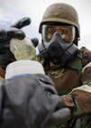 Senior Airman Jessica Wissenbach, 419th Civil Engineering Squadron, places a simulated chemical agent into a secure container for testing during an exercise here this weekend. Wissenbach is an emergency management specialist and trained to identify and dispose of hazardous material. (U.S. Air Force photo/ Tech Sgt. Richard Gonzales)