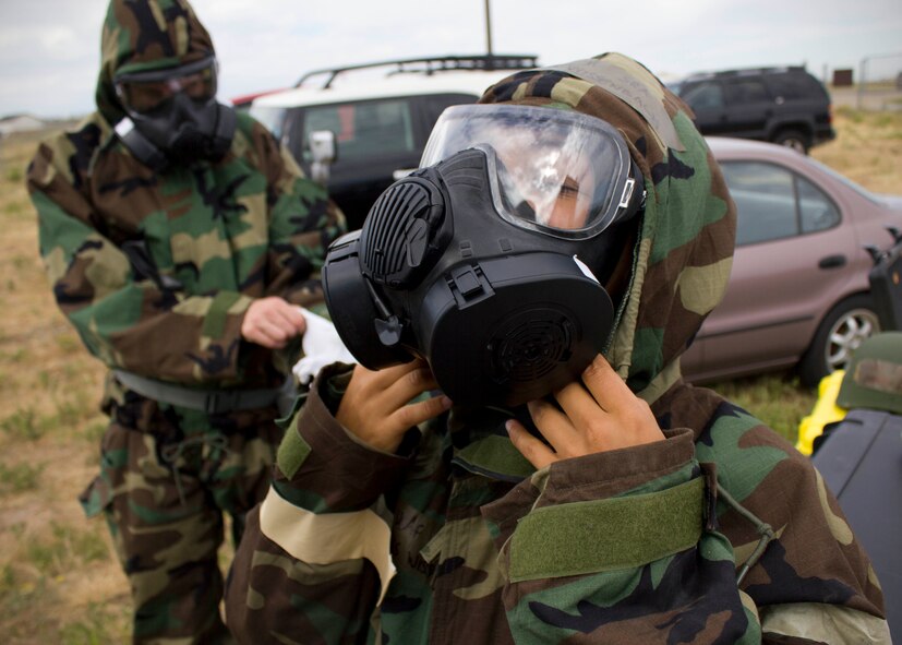 Senior Airman Jessica Wissenbach, 419th Civil Engineering Squadron, suits up to inspect a simulated chemical agent during an exercise here this weekend. Wissenbach and her partner Senior Airman Andrew Adkins—both emergency management specialists—responded to a report of a simulated chemical agent. In a deployed location, emergency management is responsible for identifying and disposing of hazardous materials.  (U.S. Air Force photo/ Tech Sgt. Richard Gonzales)