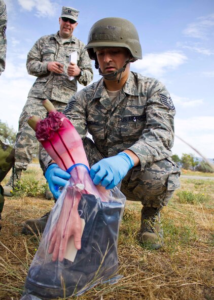 Tech Sgt. Daniel Crandall, 419th Services Sustainment Flight, bags dummy body parts during a post attack reconnaissance sweep as part of an exercise here this weekend. Crandall and other 419th reservists checked the area for unexploded ordnance and casualties after a simulated base attack. In a deployed location, reservists may be called to organize and lead PAR sweeps to keep the base up and running. (U.S. Air Force photo/ Tech Sgt. Richard Gonzales)
