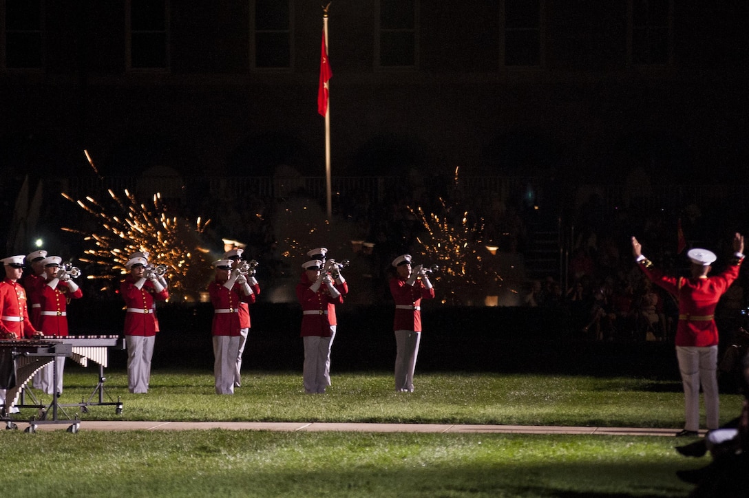 The U.S. Marine Drum & Bugle Corps performs as the Body Bearers fire ceremonial cannons during a Friday Evening Parade at Marine Barracks Washington, D.C., Aug. 23. (Official Marine Corps photo by Lance Cpl. Dan Hosack/Released)