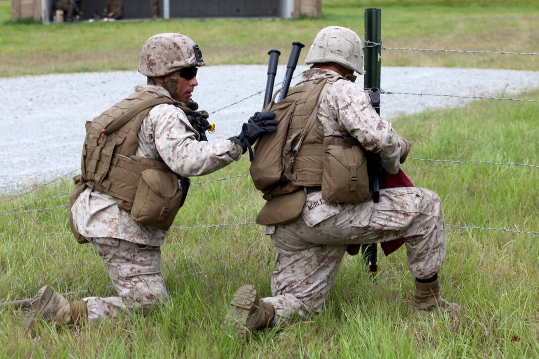 A Marine with 2nd Combat Engineer Battalion, 2nd Marine Division prepares to cut through concertina wire obstacles during a training exercise June 06, 2013. During the exercise, the Marines refreshed their patrolling, obstacle breaching and dynamic entry with shotgun skills.