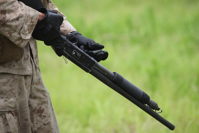 A Marine with 2nd Combat Engineer Battalion, 2nd Marine Division loads a Mossberg 500 shotgun during a training exercise June 06, 2013. During the exercise, the Marines refreshed their patrolling, obstacle breaching and dynamic entry with shotgun skills.