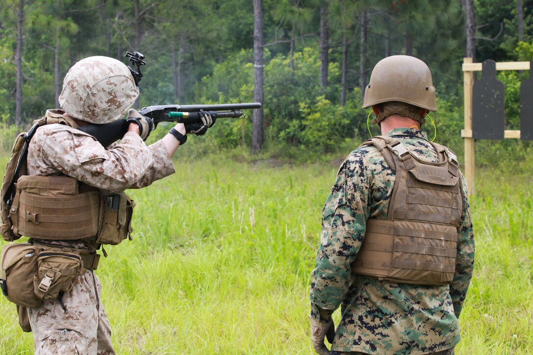 Sergeant Maj. Bryan Zickefoose, the 2nd Marine Division sergeant major, watches as Marines with 2nd Combat Engineer Battalion, 2nd Marine Division fire a Mossberg 500 shotgun during a training exercise June 06, 2013. During the exercise, the Marines refreshed their patrolling, obstacle breaching and dynamic entry with shotgun skills.