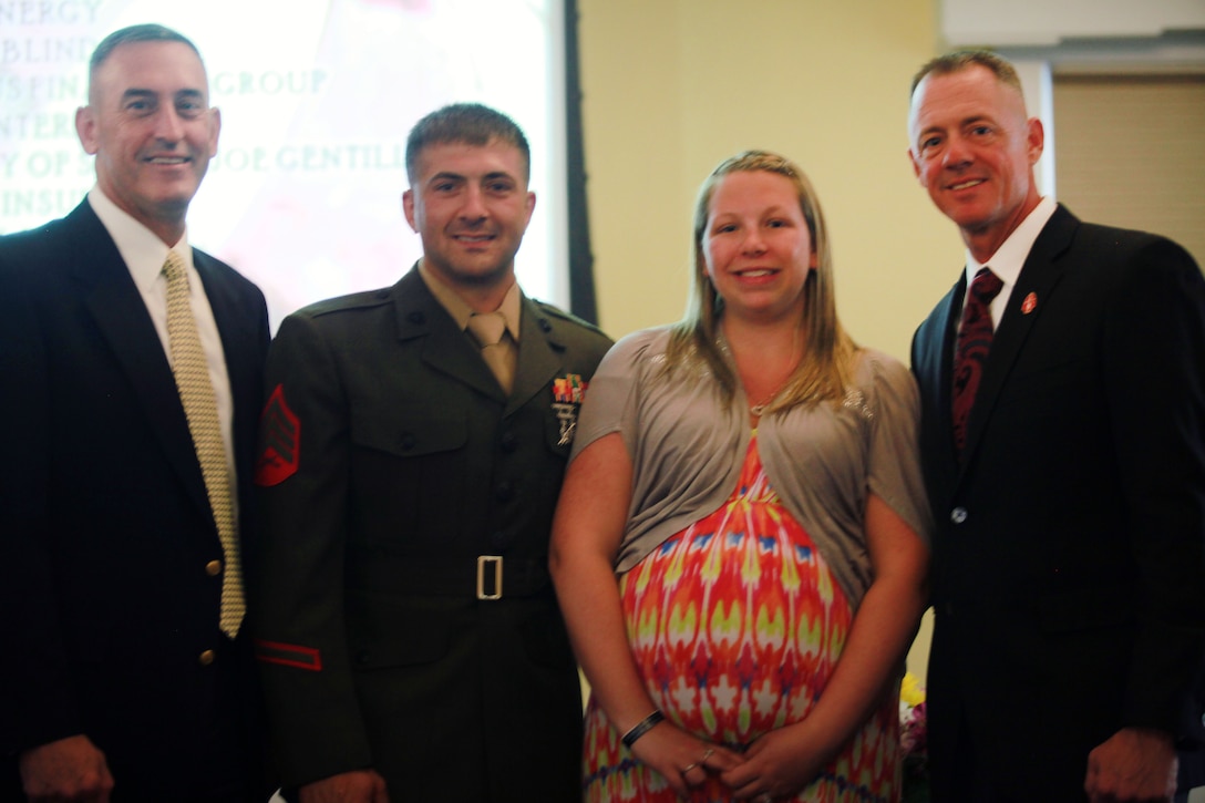 From left to right, Brig. Gen. James Lukeman, 2nd Marine Division's commanding general, Sgt. William Seniw, a tank gunner with 2nd Tank Battalion, Sgt. Seniw's wife, Ashley, and Sgt. Maj. Bryan Zickefoose, 2nd Marine Division's Sgt. Maj., stand together after Seniw's awards ceremony, June 17, 2013. Sgt. Seniw was awarded service member of the month for outstanding service.