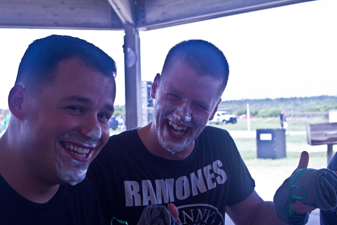 Cpl. Colton Sturm, a data technician from Fort Wayne, Ind. and Lance Cpl. Anthony Visuano, a data technician from Salem, Ore. pose after the pie-eating contest at 2nd Marine Regiment's fourth annual Beach Bash, July 2, 2013 at Onslow Beach. The contest rules gave contestants three minutes to eat an apple, marshmallow pie without using their hands. To win they had to eat the most pie within the time limit.
