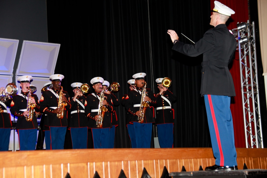 Chief Warrant Officer 2 Jack K. Davis, the band officer of the 2nd Marine Division Band, orchestrates his Marines during a Fourth of July performance aboard Marine Corps Base Camp Lejeune, July 2, 2013. "It's an honor. I do it for the Marines who have served before me and who are currently serving," said Cpl. Jacob Reeves, a piccolo player from Dexter, Mo.
