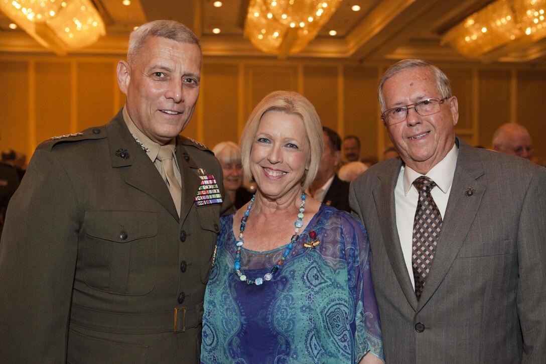 The Assistant Commandant of the Marine Corps, Gen. John M. Paxton, Jr., right, shakes hands with a Marine while passing out awards for serving in the Vietnam War during the Third Marine Divison Association Banquet in Alexandria, VA, Aug. 17, 2013. This year marked the 59th annual family reunion banquet held at the Hilton Alexandria Mark Center. (U.S. Marine Corps photo by Cpl. Tia Dufour/Released)