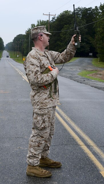 Maj. Justin Betz, air officer for The Basic School, raises his radio to make contact with incoming aircraft from Marine Medium Tiltrotor Training Squadron at LZ 7 on Aug. 23, 2013. VMMT-204 spearheaded the Osprey’s integration into the Corps arsenal.