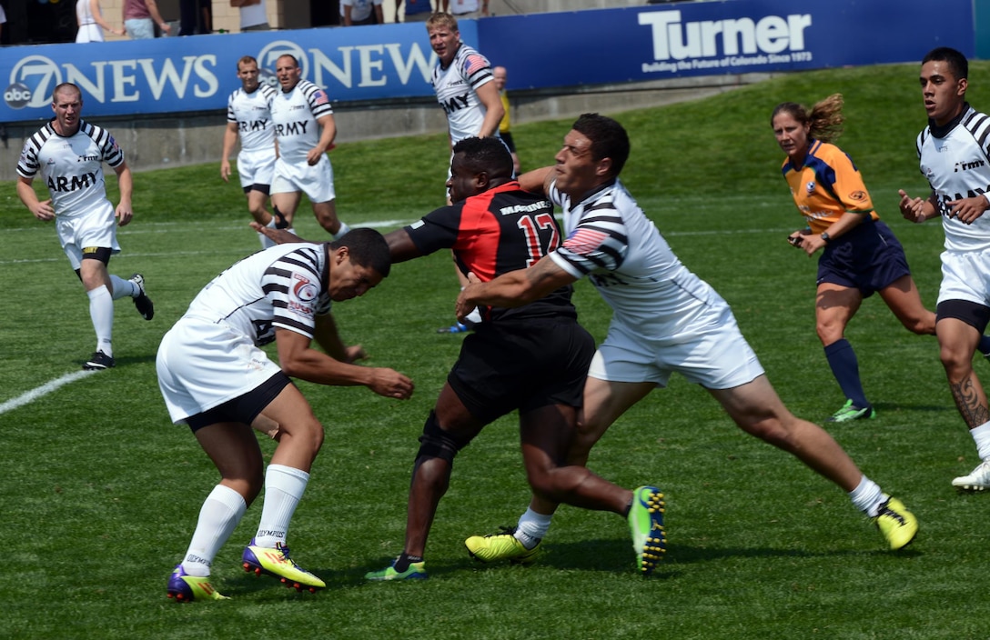 All-Army rugby players attempt to stop Sgt. George Davis of Stafford, Va., who is stationed at Marine Corps Air Station Miramar, Calif., during All-Marine Corps' 21-15 victory Saturday over All-Army at the 2013 Armed Forces Rugby Championships in Glendale, Colo. U.S. Army photo by Tim Hipps, IMCOM Public Affairs