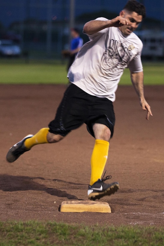 Clay Patterson, a batter for Combat Logistics Battalion 3, runs across third base on his way to the home plate during a softball match between 3rd Marine Regiment #2 and CLB-3 at Annex Field aboard Marine Corps Base Hawaii, Aug. 19, 2013. (U.S. Marine Corps photo by Lance Cpl. Matthew Bragg)