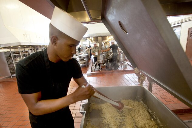 Sgt. Kendall Joseph, 24, a food service specialist with Headquarters Battalion and native of New Orleans stirs up his homemade mushroom risotto during the Chef of the Quarter competition, Aug. 21, 2013. Joseph will go on to compete in the Chef of the Year Competition for best chef of 2013 aboard Marine Corps Base Hawaii. (U.S. Marine Corps photo by Lance Cpl. Nathan Knapke)