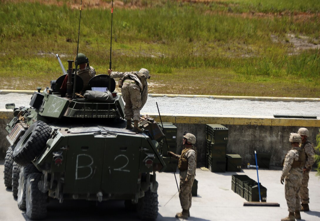 Marines with 2nd Light Armored Reconnaissance Battalion, Bravo Company, prepare to clean out the gun on a light armored vehicle 25A2 after firing it for a gunnery exercise at Shooting Range 7, August 5, 2013. This exercise is part of biannual gunner qualifications in which the Marines compete for the title 'top gun'.