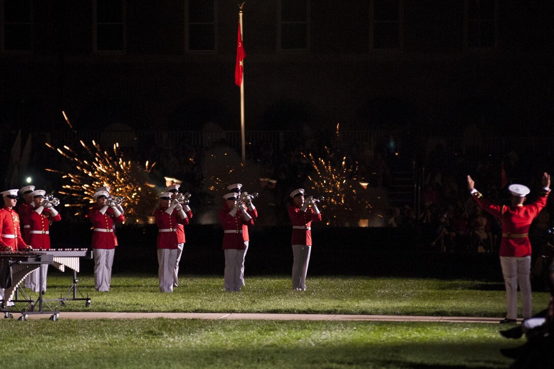 The U.S. Marine Drum & Bugle Corps performs as the Body Bearers fire ceremonial cannons during a Friday Evening Parade at Marine Barracks Washington, D.C., Aug. 23. (Official Marine Corps photo by Lance Cpl. Dan Hosack/Released)