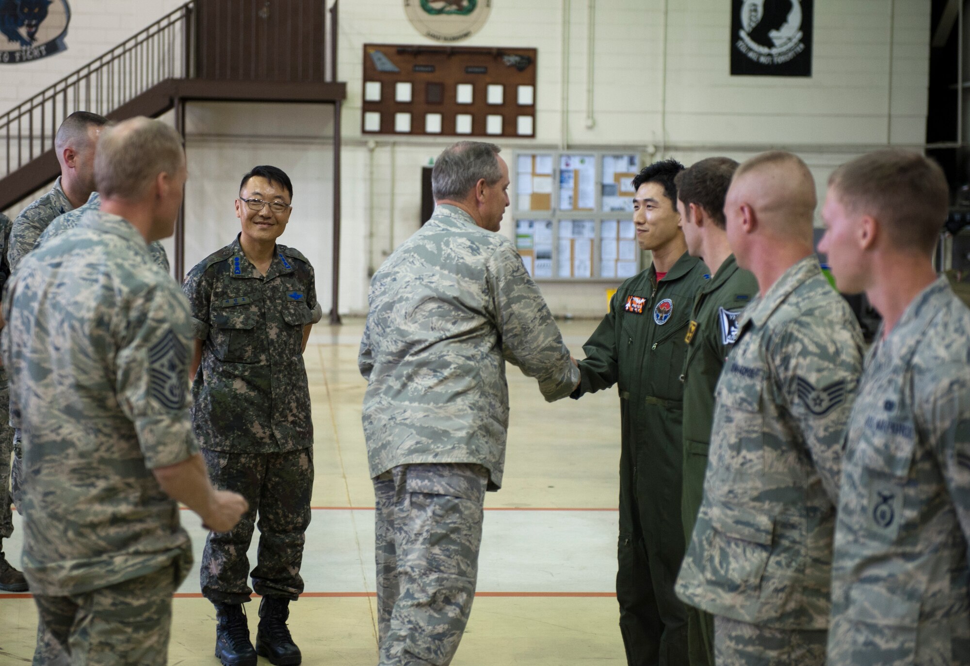 KUNSAN AIR BASE, Republic of Korea -- Capt. Jin Haejon, Republic of Korea air force 38th Fighter Group, is coined by Air Force Chief of Staff Gen. Mark A. Welsh III after briefing him on the partnership between the U.S. and Republic of Korea air forces Aug. 24, 2013. Welsh, along with Chief Master Sgt. of the Air Force James A. Cody, visited Kunsan as part of a tour to thank Pacific Air Forces Airmen and families for their support and dedication and discuss the challenges and opportunities in the region. (U.S. Air Force photo by Senior Airman Armando A. Schwier-Morales/Released)
