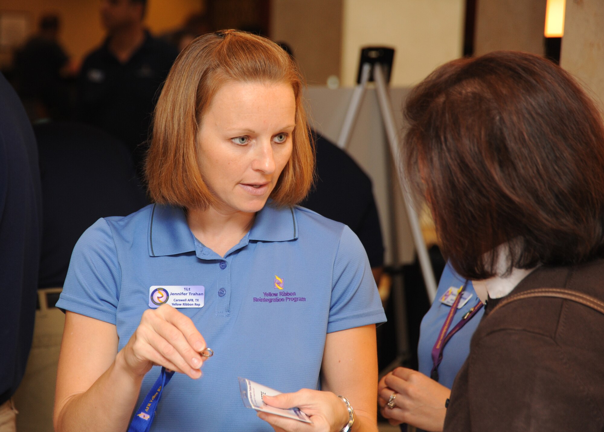 1st Lt. Jennifer Trahan, a Yellow Ribbon Program representative from Carswell AFB, issues a name tag to a Yellow Ribbon Program participant at an event in Arlington, Va., on Aug. 23, 2013.  The Air Force Yellow Ribbon Program provides Reserve members and their families with information, services, referrals, and proactive outreach opportunities throughout the deployment cycle.  (U.S. Air Force photo by Tech. Sgt. Peter R. Miller).