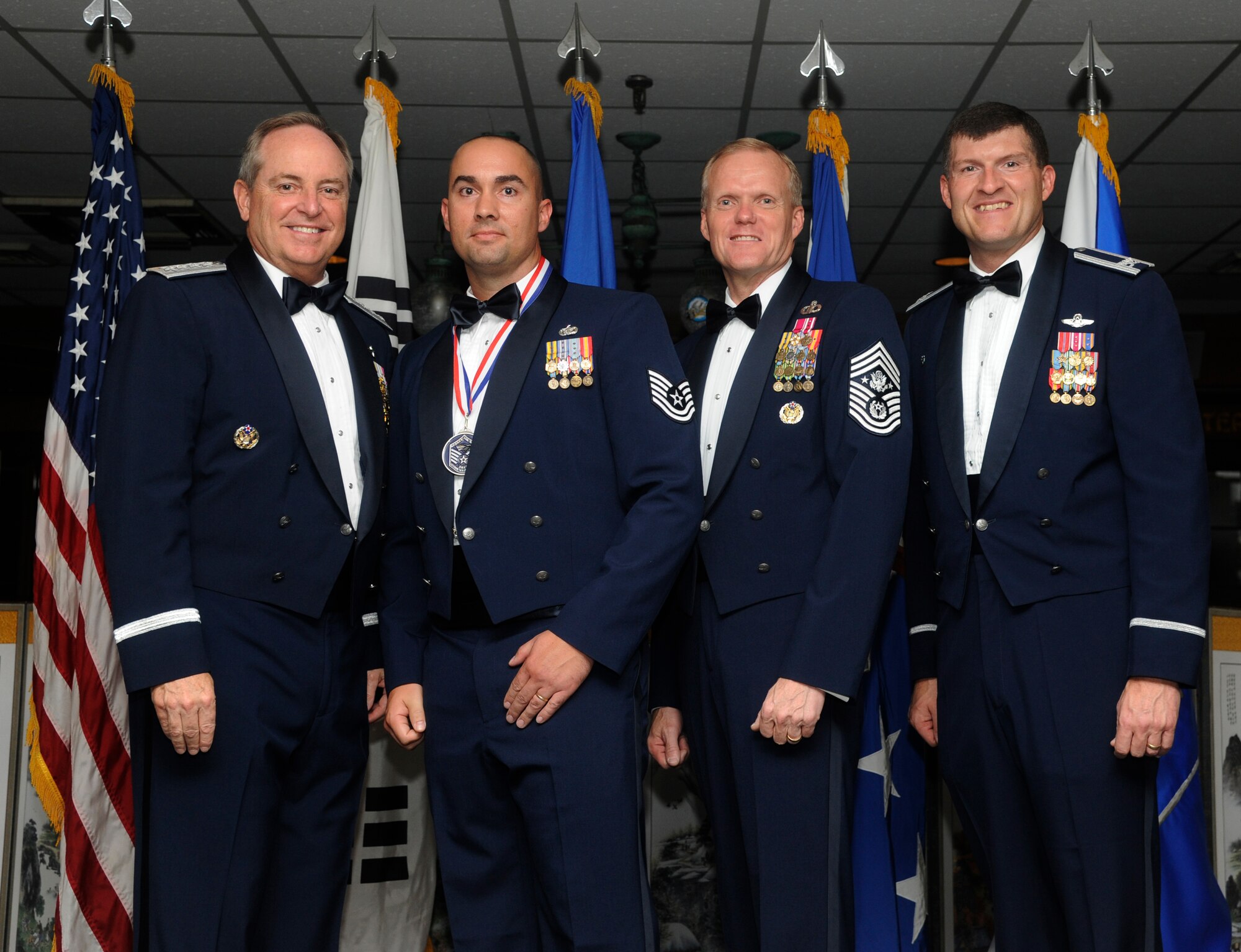 KUNSAN AIR BASE, Republic of Korea -- Tech. Sgt. Joseph Feigel, 8th Security Forces Squadron, poses for a photo with Air Force Chief of Staff Gen. Mark A. Welsh III, Chief Master Sgt. of the Air Force James A. Cody, and Col. S. Clinton Hinote, 8th Fighter Wing commander, during a Senior Noncommissioned Officer Induction Ceremony Aug. 23, 2013. Welsh and Cody attended the ceremony during their visit to Kunsan to thank Airmen for the continued service and dedication. (U.S. Air Force photo by Staff Sgt. Jessica Haas/Released)