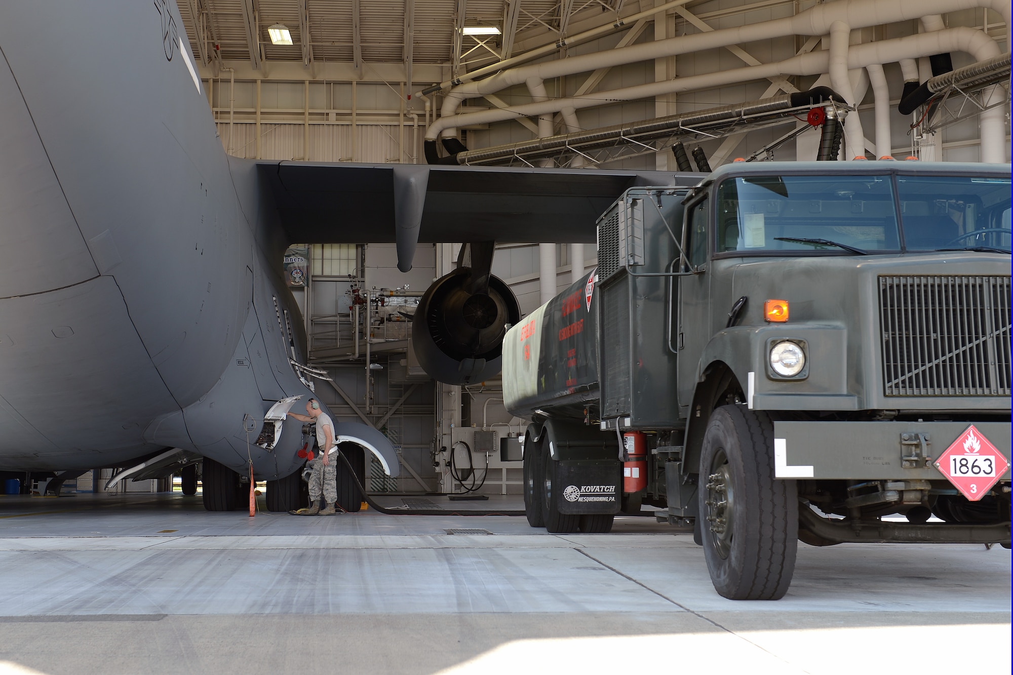 Airman 1st Class Benjamin Walker, 62nd Maintenance Squadron aircraft fuels systems technician, pumps the final 90,000 pounds of fuel into a C-17 Globemaster III aircraft, Aug. 16, 2013, prior to an operational check at Joint Base Lewis-McChord, Wash. Fuels systems Airmen are responsible for inspecting, repairing, removing, installing and modifying aircraft fuel systems, cells and water cell tanks. (U.S. Air Force photo/Airman 1st Class Jacob Jimenez)