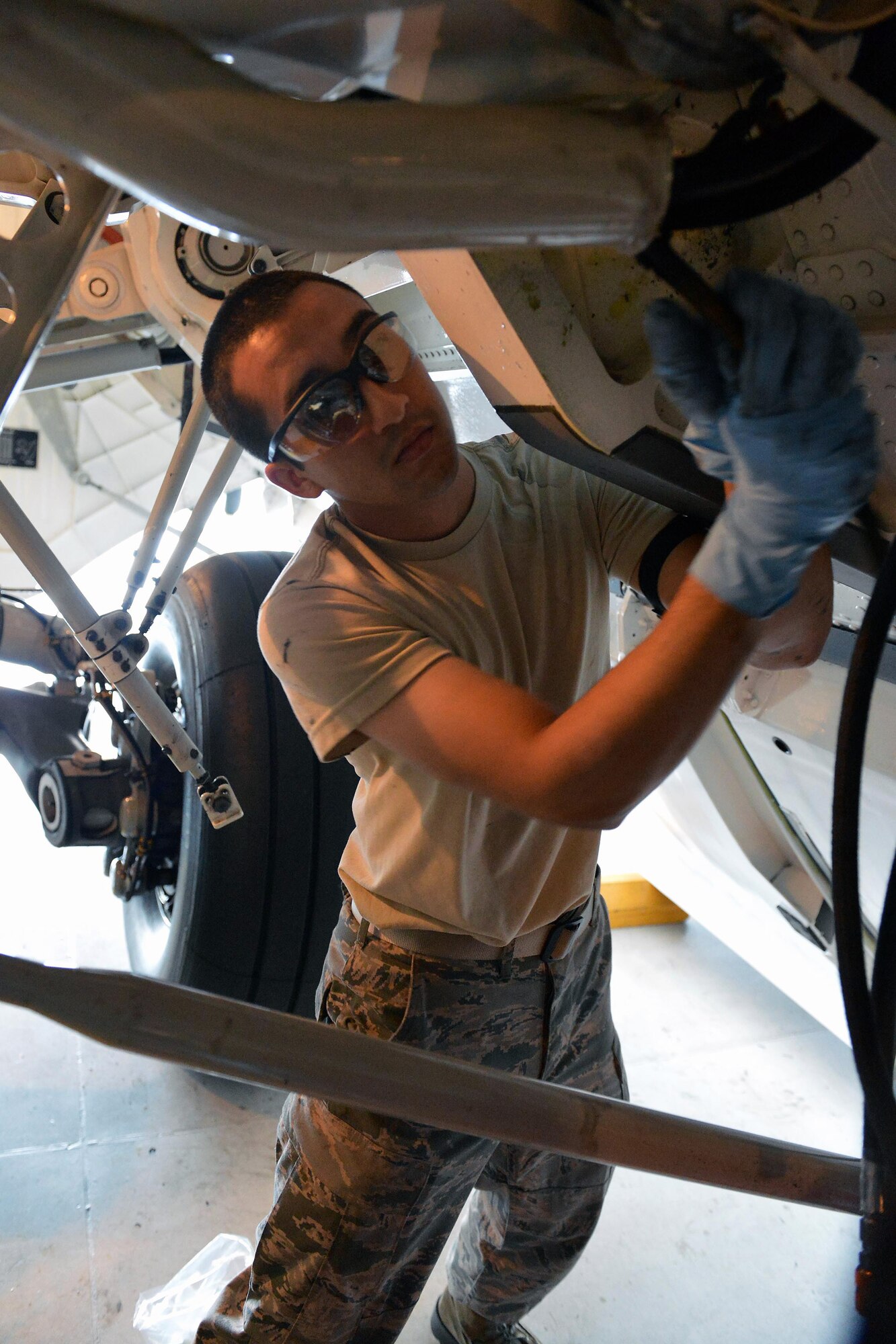 Airman 1st Class Troy Miller, 62nd Maintenance Squadron aircraft hydraulics technician, removes a worn brake line from a C-17 Globemaster III aircraft, July 30, 2013, at Joint Base Lewis-McChord, Wash. McChord’s accessories flight’s aircraft hydraulic technicians inspect, troubleshoot and maintain C-17 aircraft hydraulic systems and components. (U.S. Air Force photo/Airman 1st Class Jacob Jimenez)  