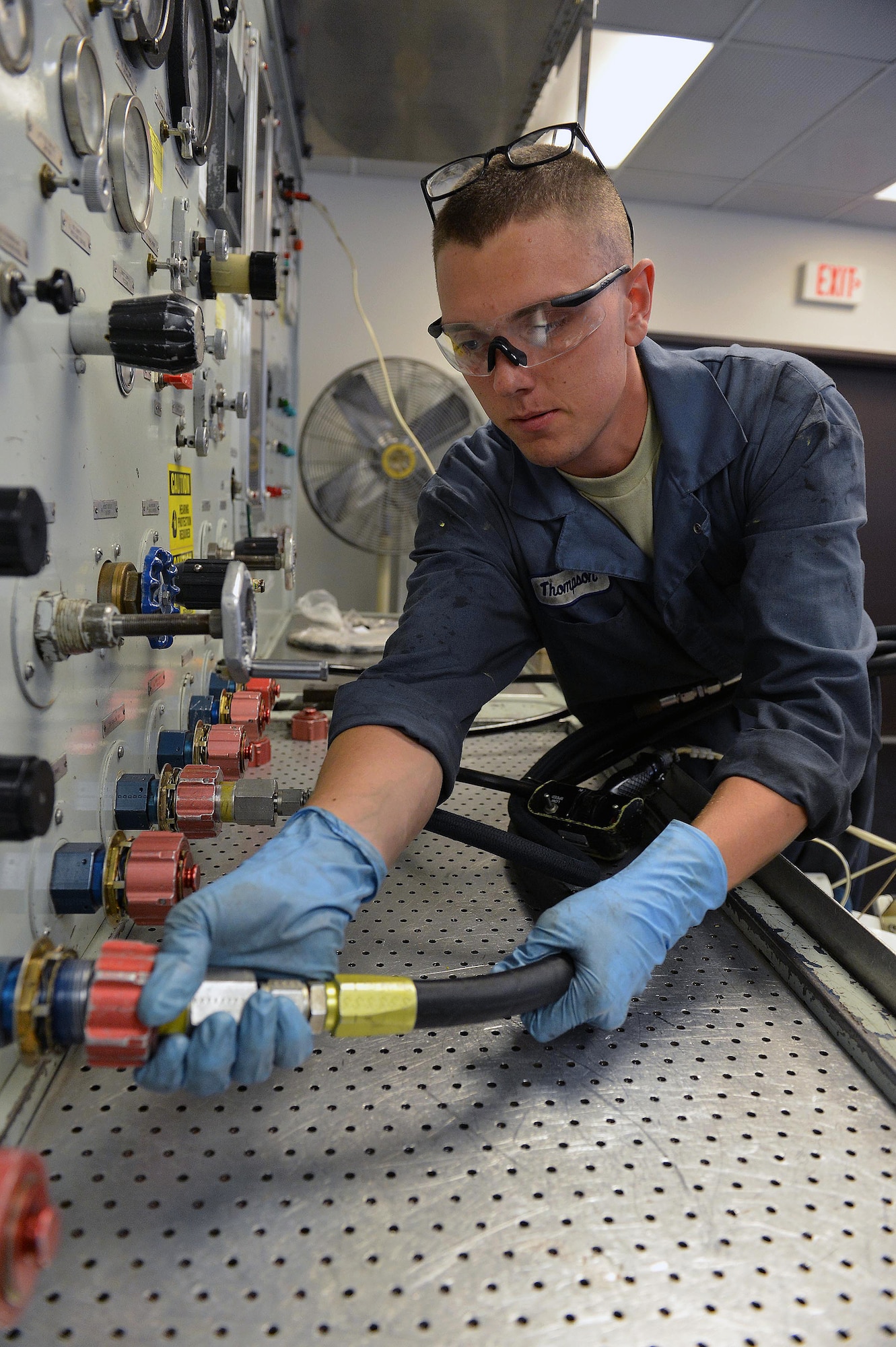 Airman 1st Class Sean Thompson, 62nd Maintenance Squadron accessories flight hydraulics technician, attaches a hydraulic line to a pump, July 30, 2013, at Joint Base Lewis-McChord, Wash. The flight is composed of the hydraulics shop, the electrical and environmental shop and the fuels systems shop. (U.S. Air Force photo/Airman 1st Class Jacob Jimenez)  