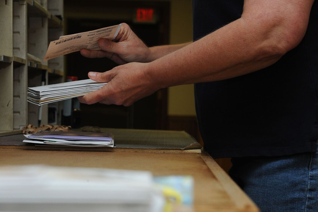 Lori Steever, 28th Communications Squadron Postal Service Center project manager, sorts incoming mail at the PSC on Ellsworth Air Force Base, S.D., Aug. 15, 2013. The PSC is responsible for receiving, sorting and delivering mail to more than 750 Airmen in six dormitory buildings. (U.S. Air Force photo by Airman 1st Class Rebecca Imwalle/Released)
