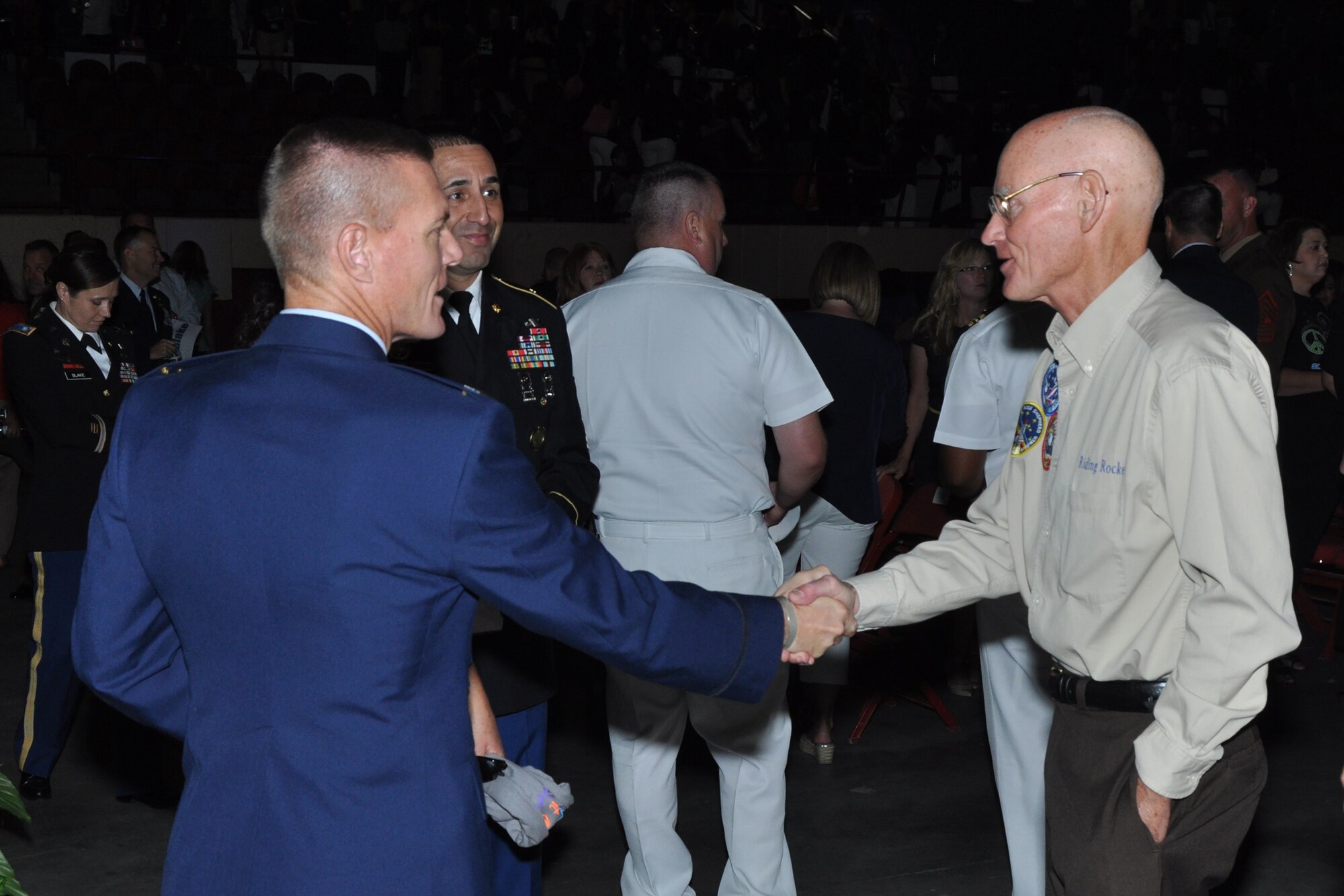 SAN ANGELO, Texas – Col. Brendan Harris, 17th Training Group Commander, and Army Command Sgt. Maj. Matt Coppi, Army 344th Military Intelligence Battalion command sergeant major, introduce themselves to former astronaut Mike Mullane, SAISD convocation guest speaker, after the San Angelo Independent School District convocation at the Foster Communications Coliseum Aug. 22. Mullane also met with Army Lt. Col. Devon Blake, Army 344th MIB Commander, and Marine Corps Maj. Devin Rullman, Marine Corps Detachment Commander. (U.S. Air Force photo/ Airman 1st Class Joshua Edwards)