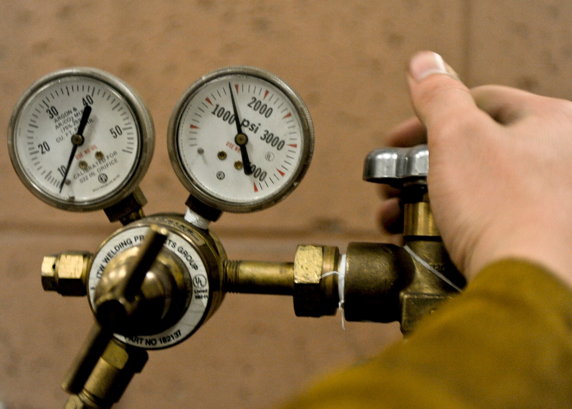 Airman 1st Class Joshua Soucy, 28th Maintenance Squadron aircraft metals technician, turns on the shielding gas machine at the welding shop on Ellsworth Air Force Base, S.D., Aug. 16, 2013. Shielding gas, made up of 75 percent Argon and 25 percent Carbon Dioxide, protects the emanating melting heat from the surrounding atmosphere, stabilizing the electric arc which fuses together the pieces being welded. (U.S. Air Force photo by Airman 1st Class Anania Tekurio/Released)