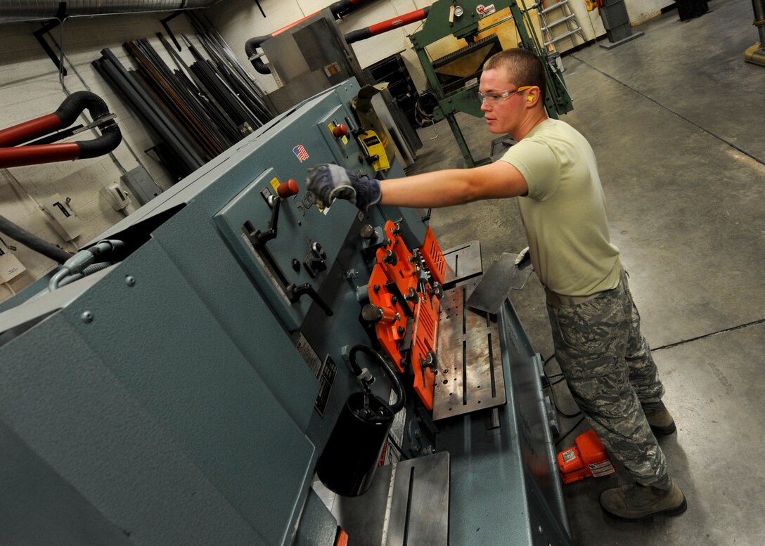 Airman 1st Class Joshua Soucy, 28th Maintenance Squadron aircraft metals technician, turns on the shear machine at the welding shop on Ellsworth Air Force Base, S.D., Aug. 16, 2013. The machine is used to shear and punch holes into metal, which is an integral step in creating and repairing parts for the B-1 bomber. (U.S. Air Force photo by Airman 1st Class Anania Tekurio/Released)