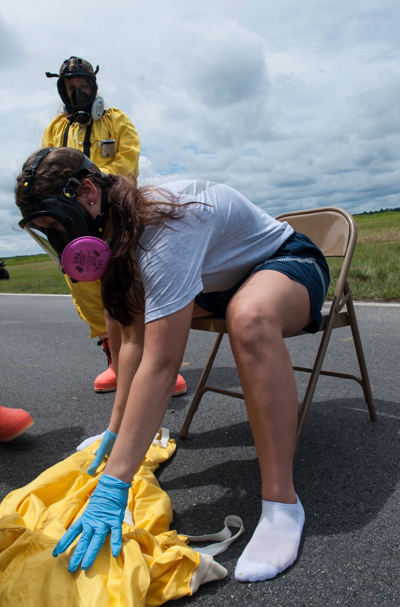 U.S. Air Force Airman 1st Class Bryana Hodge, 23d Medical Group bioenvironmental engineering technician, removes her radiation suit at a decontamination station during a nuclear weapons incident exercise at Moody Air Force Base, Ga., Aug. 16, 2013. The surprise exercise was meant to test Moody Airmen’s ability to safely handle a nuclear weapons incident. (U.S. Air Force photo by Airman 1st Class Sandra Marrero/released)
