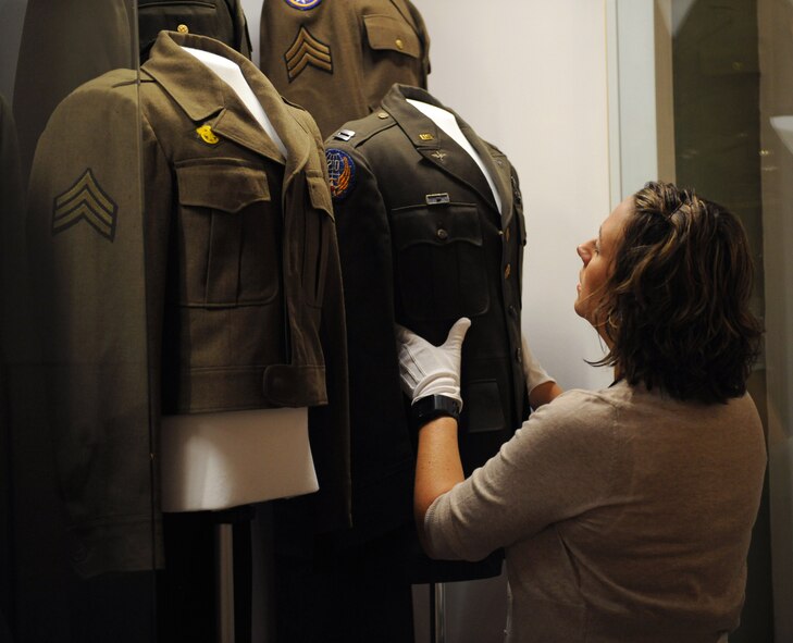 Amy Russell, Global Power Museum director, adjusts a uniform display on Barksdale Air Force Base, La., Aug. 26, 2013. The museum has various exhibits and aircraft in the air park which tell the history of the Air Force. (U.S. Air Force photo/Senior Airman Benjamin Gonsier)