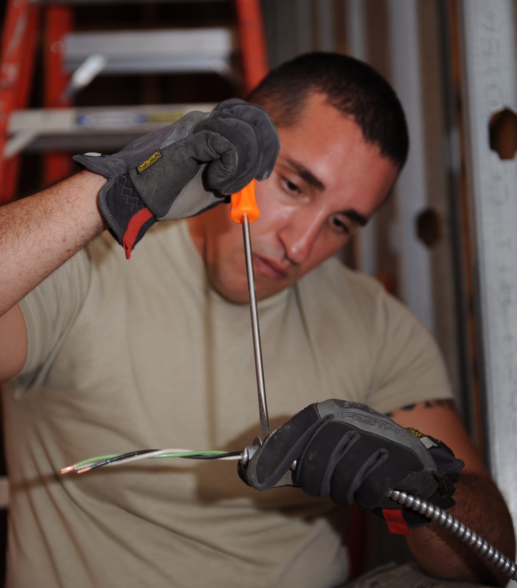 Staff Sgt. Jose Arriaga, 2nd Civil Engineer Squadron electrical planner, screws a box connector to wires for an electrical outlet at the Global Power Museum on Barksdale Air Force Base, La., Aug. 26, 2013. While most of the maintenance projects inside the museum are performed by volunteers, anything electrical needs to be conducted by electricians due to regulations. (U.S. Air Force photo/Senior Airman Benjamin Gonsier)