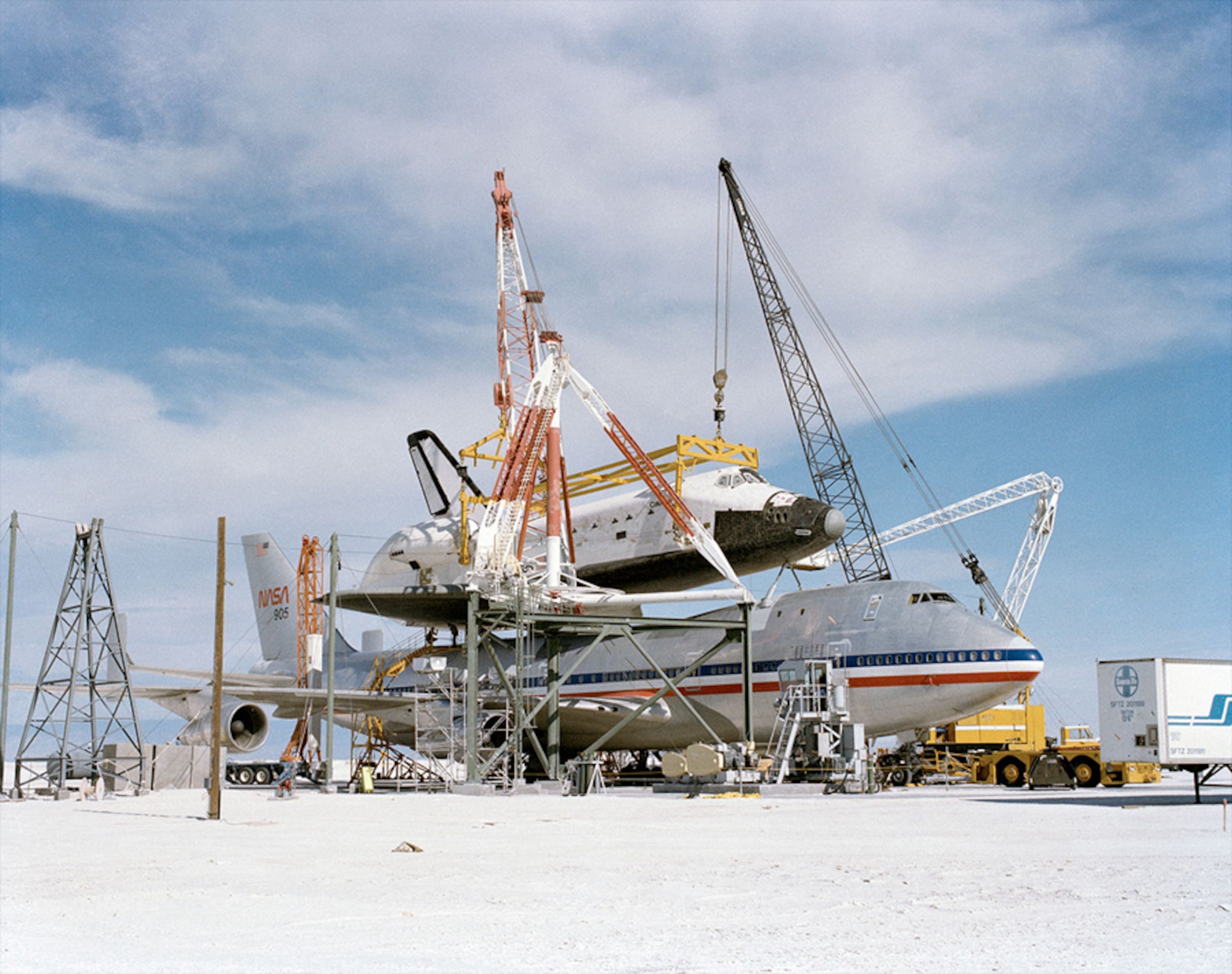 The Space Shuttle Columbia is hoisted into place by cranes at White Sands Northrup Strip. Columbia made the first, and only, shuttle landing at the New Mexico facility in March 1982 during STS-3. The shuttle was flown by Astronaut C. Gordon Fullerton, who passed away Wednesday, Aug. 21, at the age of 76. The fine gypsum sand battered the spacecraft so harshly that despite a deep cleaning and years of use, the sand was still found on subsequent missions.