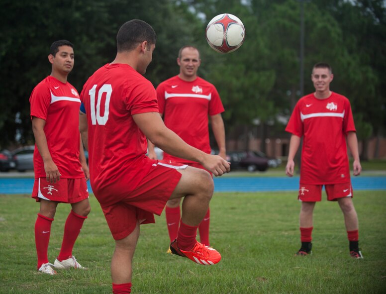 Members of the Flying Tigers Football Club volley during practice at Moody Air Force Base, Ga., Aug. 22, 2013. The players are preparing for the Defender’s Cup, an annual military soccer tournament scheduled for Labor Day weekend near Joint Base San Antonio- Lackland. (U.S. Air Force photo by Airman 1st Class Sandra Marrero/Released)
