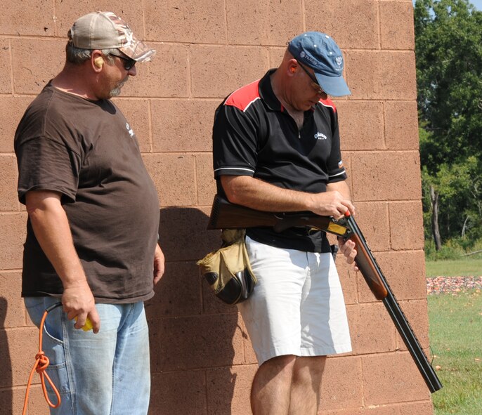 Col. Patrick Matthews, right,  2nd Mission Support Group commander, loads a shotgun at the Red Chute Shotgun Sports Club on Barksdale Air Force Base, La., Aug. 24, 2013. The club hosts more than 20 sanctioned trap and skeet events each year and supports special requests on a case-by- case basis. (U.S. Air Force photo/Senior Airman Sean Martin)