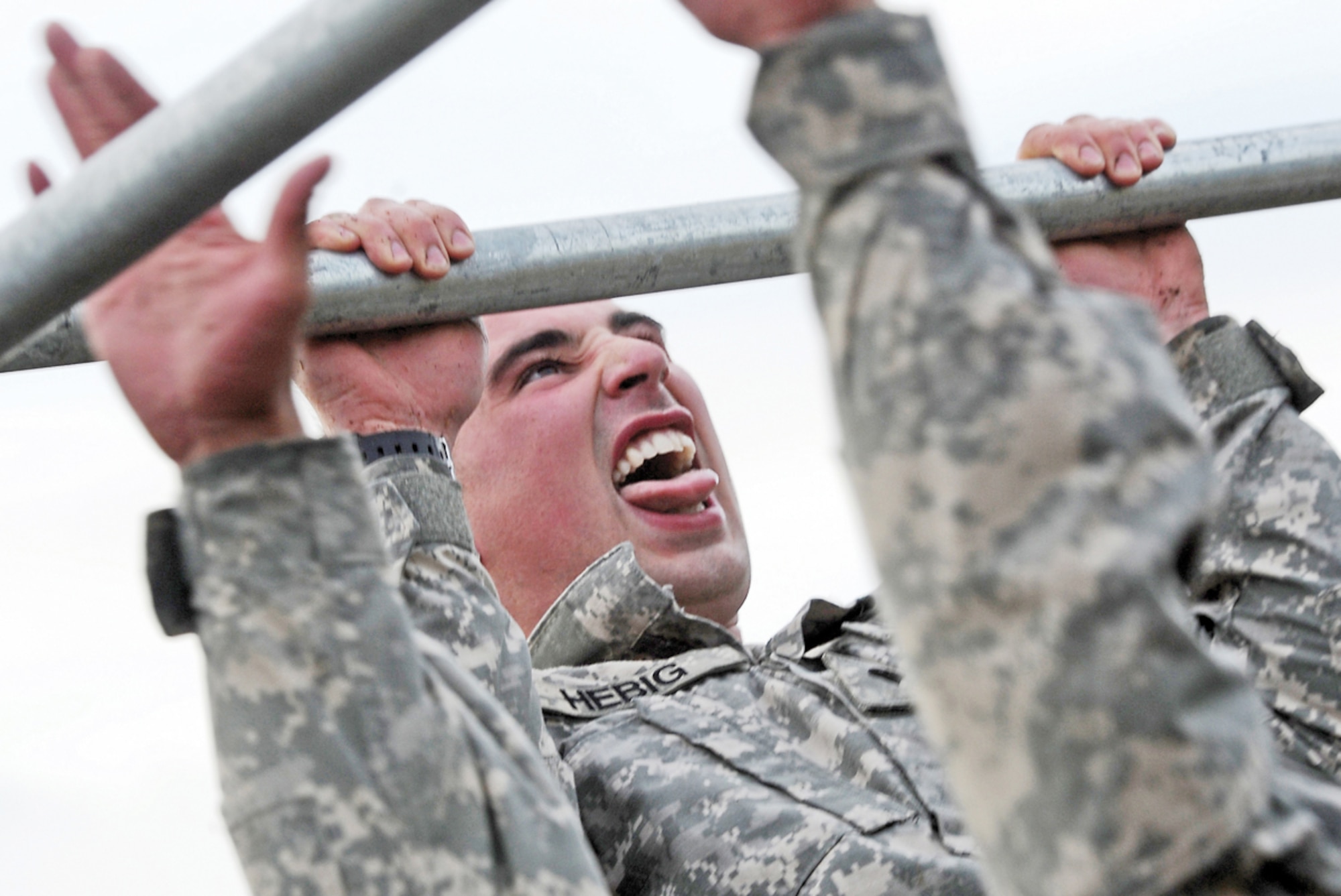 JOINT BASE ELMENDORF-RICHARDSON, Alaska -- Spc. Travis Hebig, assigned to the 6th Engineer Battalion (Combat) (Airborne), strains to pump out one last elevated pull-up in a non-standard physical fitness test during the unit's Best Soldier Competition, Tuesday, Aug. 13, 2013. Competition events include a written test, a non-standard PT test, land navigation, weapons proficiency, a road march, drill and ceremony, common tasks testing, urban orienteering, rappelling, an obstacle course and appearing before a board of senior noncommissioned officers.  (U.S. Air Force photo/Justin Connaher)