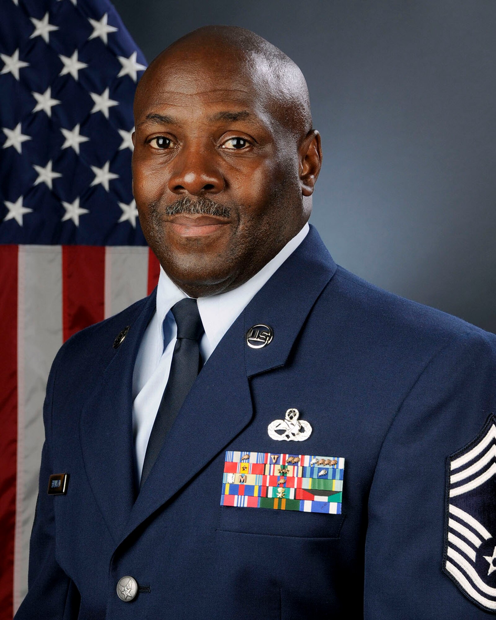 U.S. Air Force Chief Master Sgt. Joseph Brunson, a human resource advisor with Joint Forces Headquadrters at McEntire Joint National Guard Base, South Carolina Air National Guard, poses for his official portrait August 10, 2013.   (U.S. Air National Guard photo by Tech. Sgt. Caycee Watson/Released)