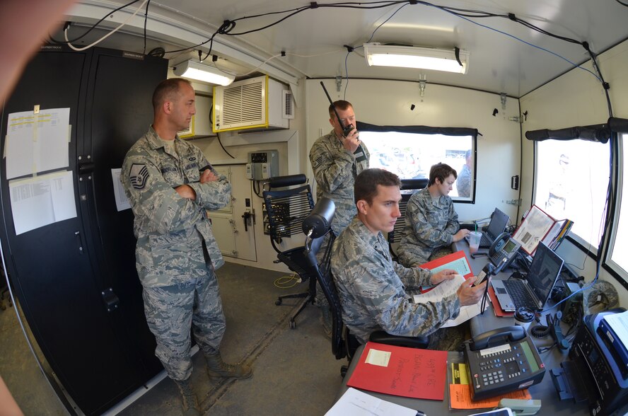 Westover's 439th Airlift Control Flight members communicate with a C-130 aircraft in Pueblo, Colorado, Aug. 24, 2013 during the annual AFRC-sponsored air mobility exercise, "Patriot Express." The ALCF is responsible for the training of Air Force and sister service units on how to move by air. They instruct over 400 units in preparing and loading their mobility equipment for air shipment. (U.S. Air Force photo/SrA. Kelly Galloway) 
