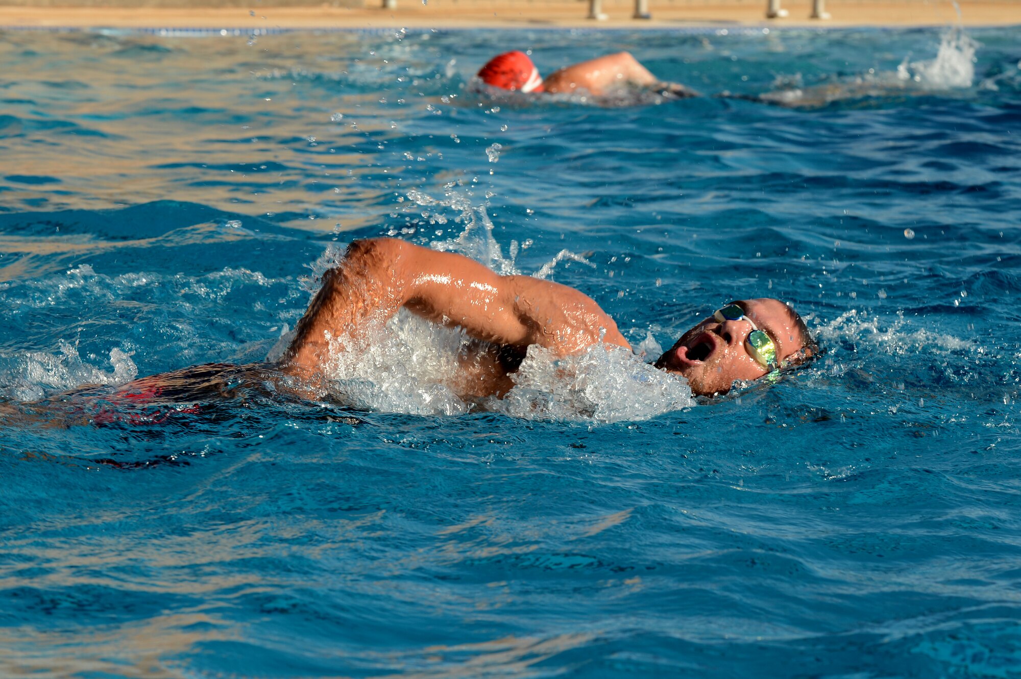 Swimmers compete in a mini triathlon at Cannon Air Force Base, N.M., Aug. 24. This fitness challenge included a 300-meter lap swim, 8.5-mile bike ride and a 3.2-mile run. (U.S. Air Force photo/Staff Sgt. Matthew Plew)