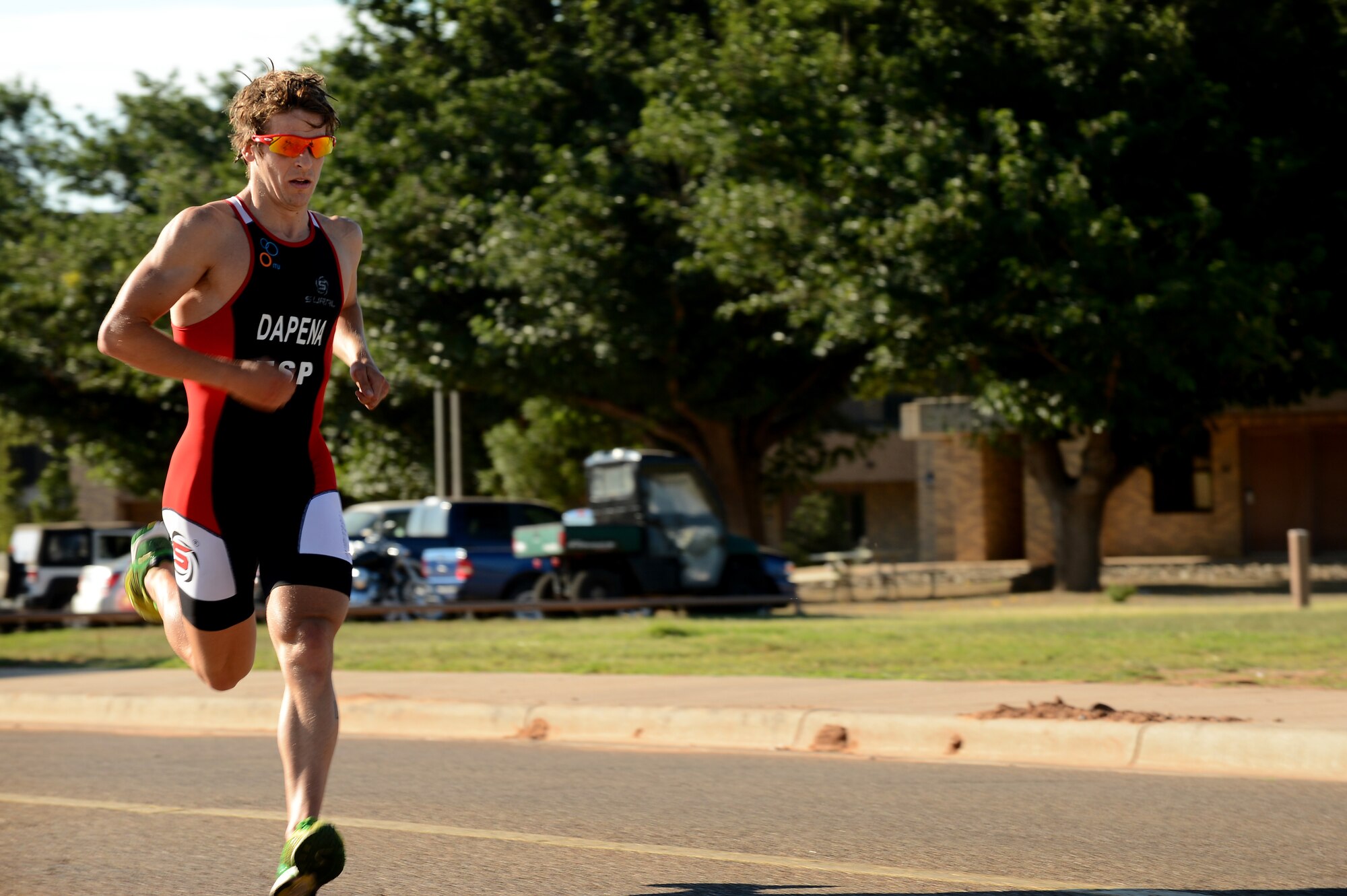 Pablo Dapena, a foreign exchange student at Clovis High School, sets off on the final leg of a mini triathlon at Cannon Air Force Base, N.M., Aug. 24. Dapena was the first to finish this fitness challenge that included a 300-meter lap swim, 8.5-mile bike ride and a 3.2-mile run in forty minutes flat. (U.S. Air Force photo/Staff Sgt. Matthew Plew)
