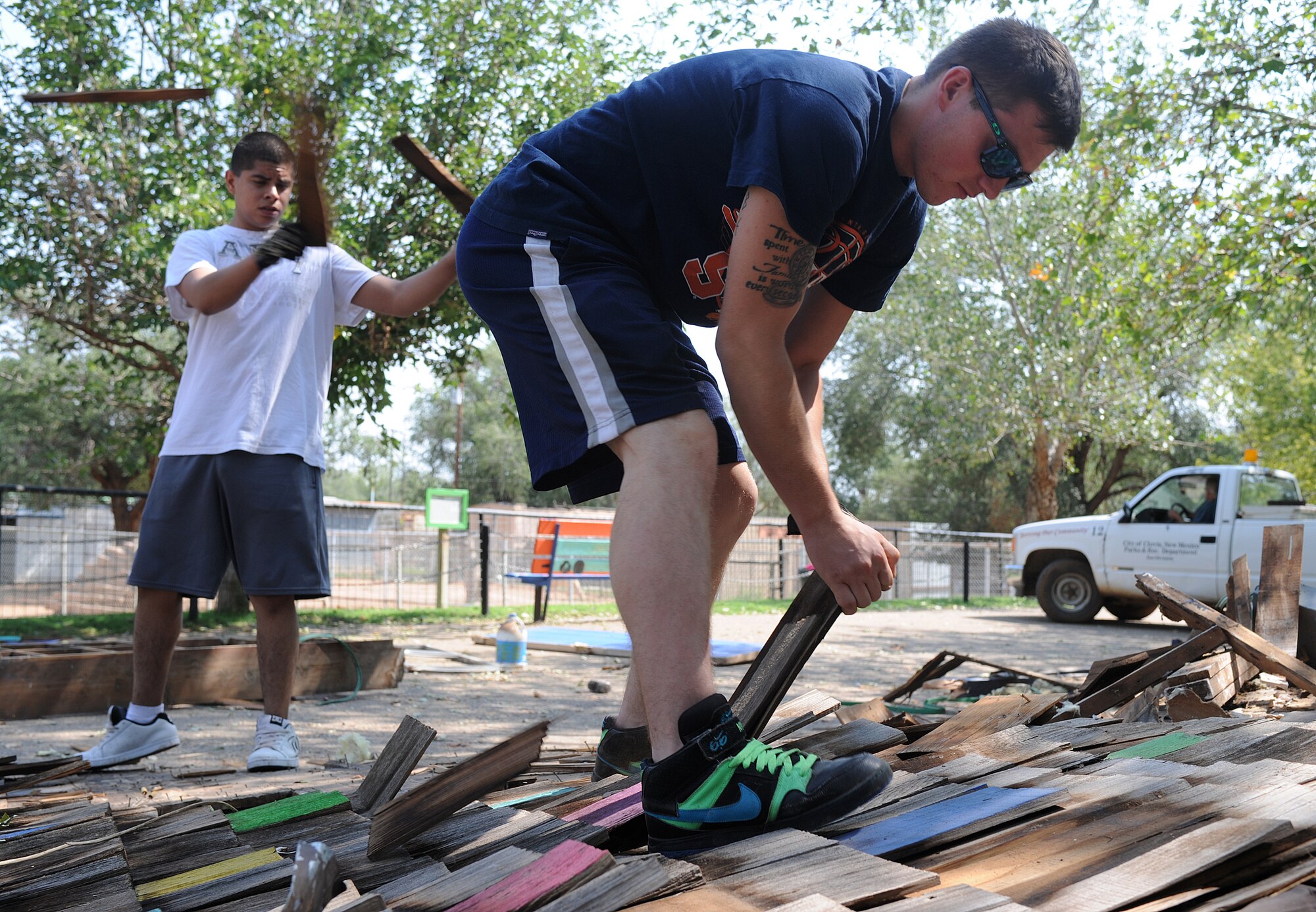 Members of the 27th Special Operations Aircraft Maintenance Squadron Booster Club tear down an outdated building Aug. 17, 2013, while volunteering at Hillcrest Park Zoo. The 27 SOAMXS Booster Club volunteers have spent many Saturday’s beautifying and improving the zoo. (U.S. Air Force photo/Senior Airman Ericka Engblom)