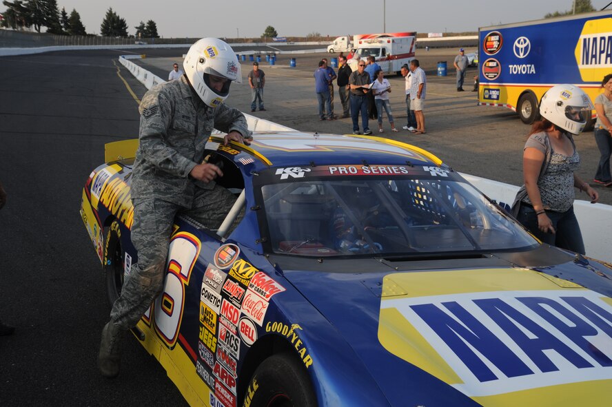 Staff Sgt. Brett Myers, 92nd Security Forces Squadron military working dog
handler, gets in a NAPA team race car at the Spokane County Raceway in Airway Heights, Wash., Aug. 23, 2013.  Throughout the week, several personnel from Fairchild got the opportunity to ride in the stock cars for three laps around the track.  (U.S. Air Force photo by Airman 1st Class Sam Fogleman/Released)
