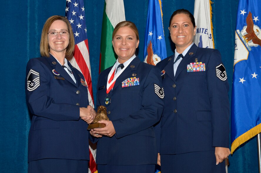 McGHEE TYSON AIR NATIONAL GUARD BASE, Tenn. - Tech. Sgt. Sara C. Klobucar, right, from Scott AFB, receives the academic achievement award for NCO Academy Class 13-7 at the I.G. Brown Training and Education Center here from Senior Master Sgt. Paula C. Shawhan, EPME Director of Education, and Master Sgt. Veronica Ross, former Director of Education, Aug. 15, 2013. The academic achievement award denotes excellence as a scholar.  It is based upon all summative objective tests and individual performance evaluations and is given to the student with the highest overall academic standing. (U.S. Air National Guard photo by Master Sgt. Kurt Skoglund/Released)