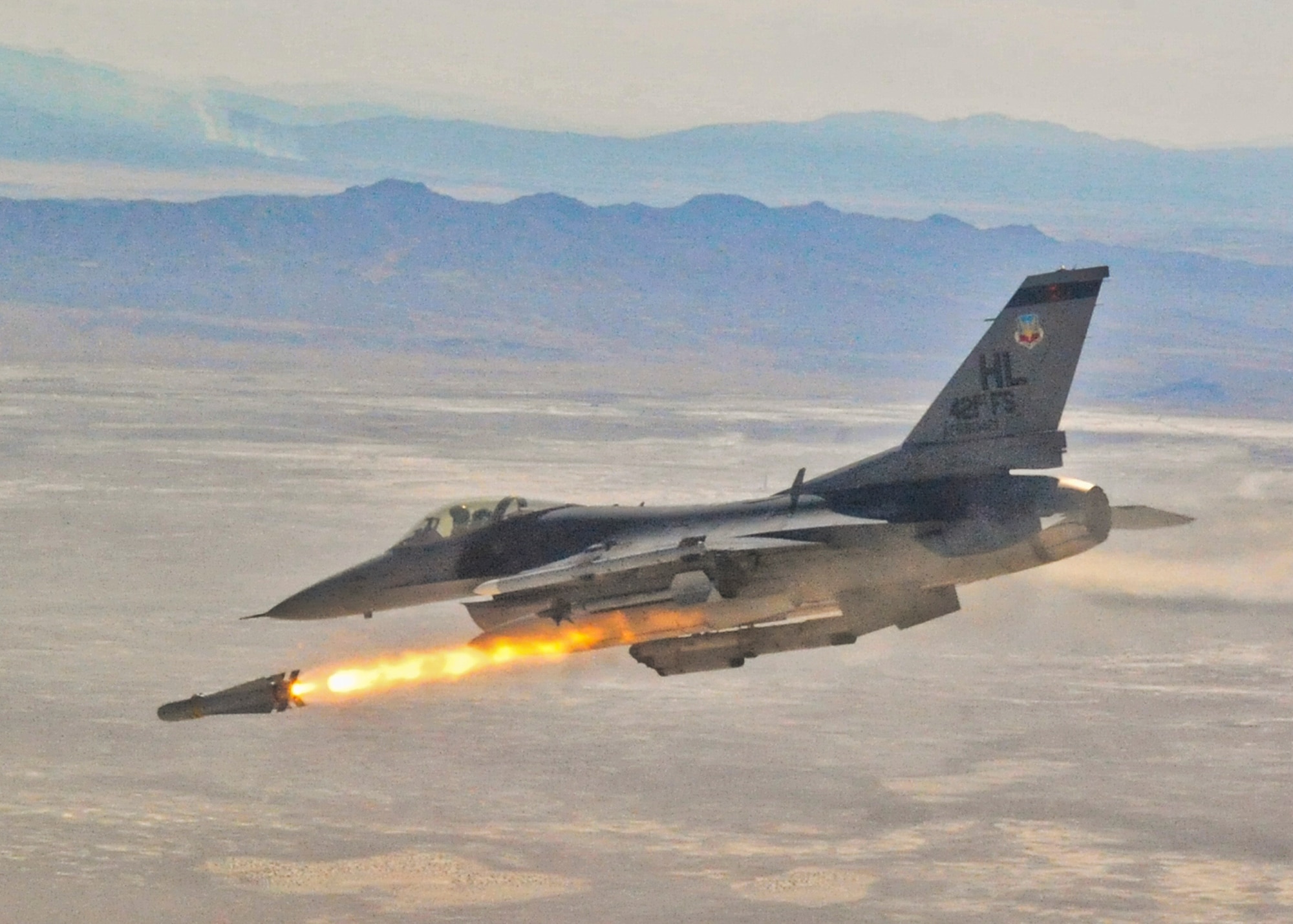 An F-16 Fighting Falcon from the 421st Fighter Squadron fires a guided bomb unit during a Weapons System Evaluation Program mission at Hill Air Force Base, Utah. The sortie was part of three weeks of evaluation at Hill by the 53rd Weapons Evaluation Group. The WSEP program is used to evaluate the effectiveness and suitability of combat air force weapon systems. The evaluations are accomplished during tactical deliveries of fighter, bomber and unmanned aerial system precision guided munitions, on realistic targets with air-to-air and surface-to-air defenses. For many of the aircrew participating in WSEP, it is the first time employing live weapons. This provides a level of combat experience many units face during combat. Courtesy photo.