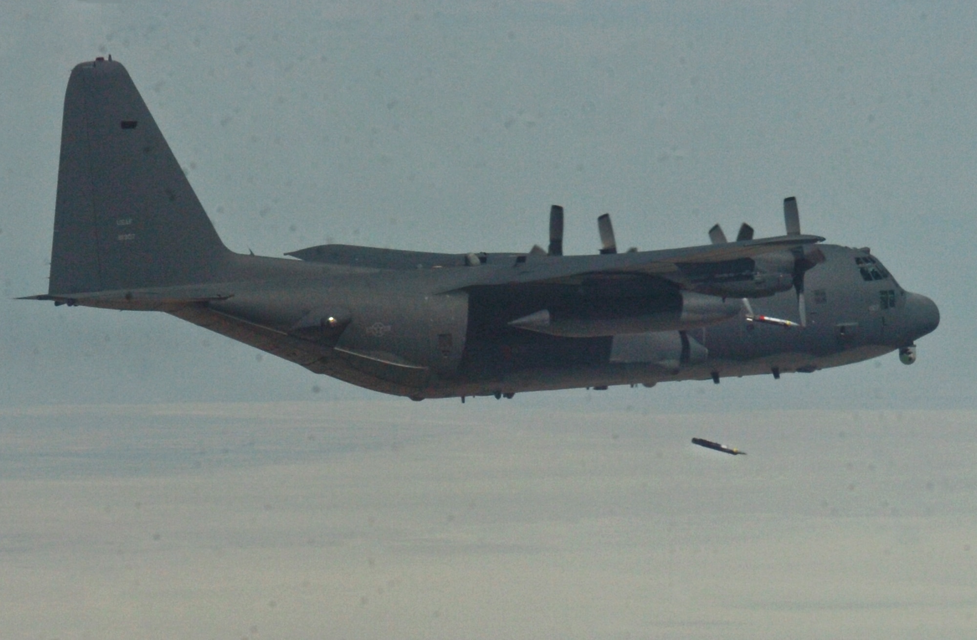 A C-130 from the 73th Special Operations Squadron from Cannon Air Force Base, N.M., releases bombs during a Weapons System Evaluation Program mission at Hill Air Force Base, Utah. This sortie is part of three weeks of evaluation at Hill by the 53rd Weapons Evaluation Group. The WSEP program is used to evaluate the effectiveness and suitability of combat air force weapon systems. The evaluations are accomplished during tactical deliveries of fighter, bomber and unmanned aerial system precision guided munitions, on realistic targets with air-to-air and surface-to-air defenses. For many of the aircrew participating in WSEP, it is the first time employing live weapons. This provides a level of combat experience many units face during combat. (Courtesy photo.)